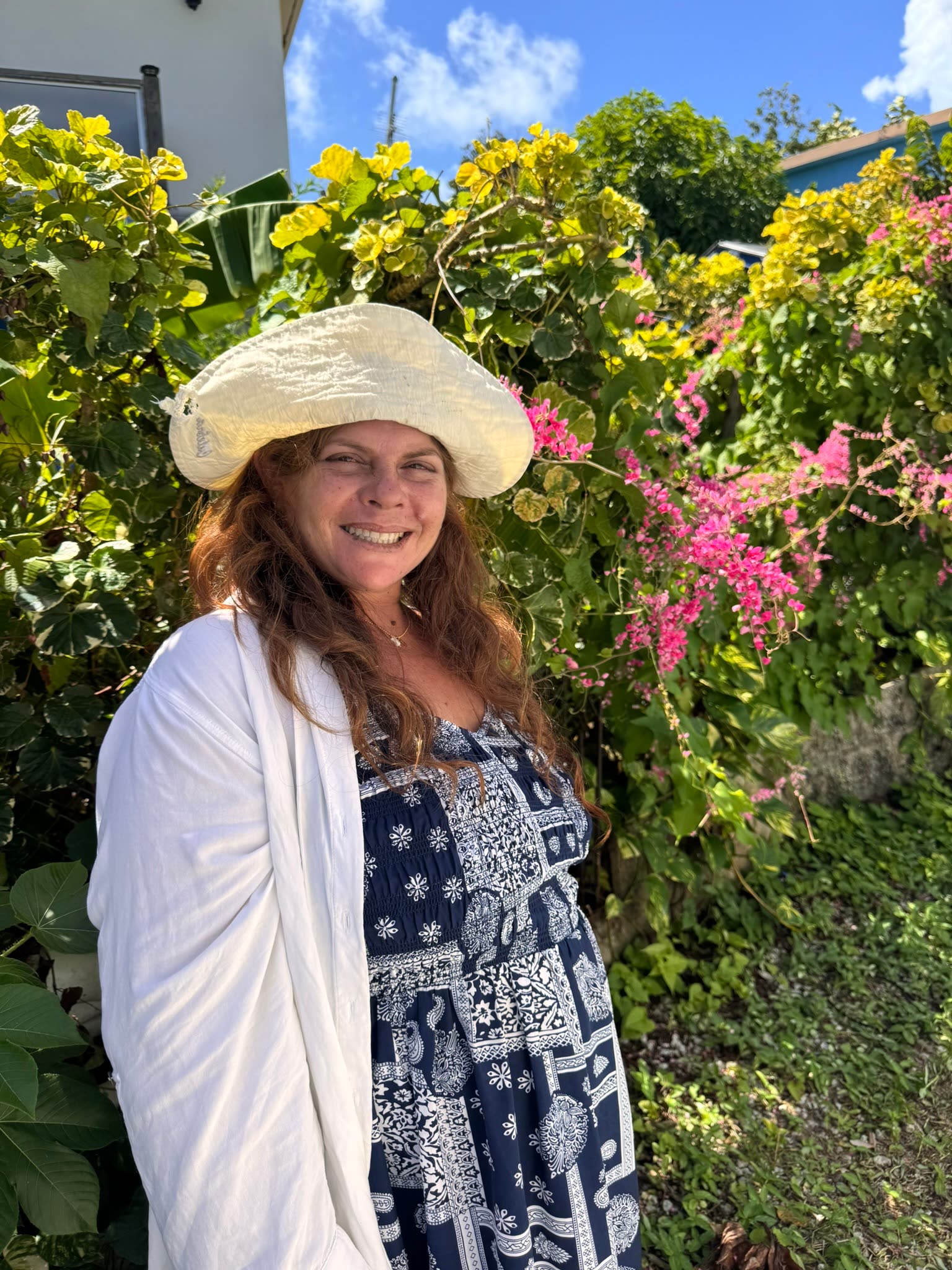 A Culebra Eden founder surrounded by tropical plants in Culebra